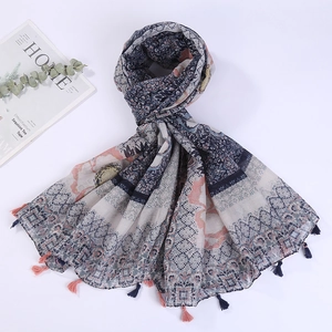 Detail of cotton linen beach scarf featuring intricate floral geometric patterns and tassels