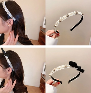 Detail of white tweed headband with rhinestones and black silk bow on model