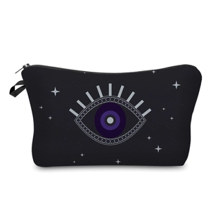 Detail view of durable black makeup bag featuring iconic evil eye pattern and side handle