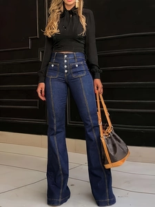 Detailopname van flared jeans met hoge taille en voorsluiting met vier knopen in donkerblauw