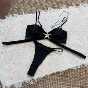 Detailed view of black bikini top featuring a central golden rhinestone starfish decoration