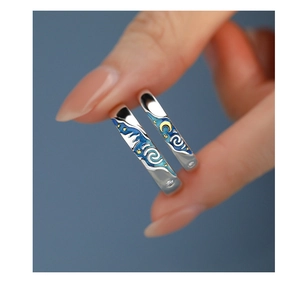 Macro shot of Van Gogh Starry Night couple rings featuring blue and yellow enamel details