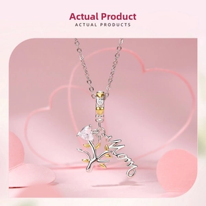 Macro detail of S925 silver Tree of Life pendant with Mom charm and gold heart accents