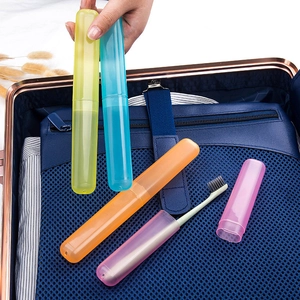 Portable macaron-colored travel toothbrush case in a blue luggage storage bag