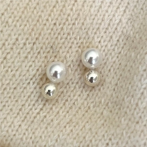 Minimalist 925 sterling silver earrings with pearl and metal ball studs on knit fabric