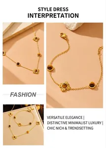 Detail of gold-plated stainless steel chain set featuring tiger eye flower pendants