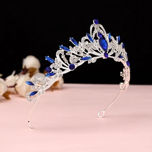 Detailed macro view of baroque silver crown with deep blue crystals and intricate filigree