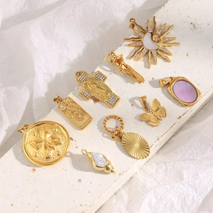 Golden stainless steel necklace charms with sun, moon and seashell designs on stone