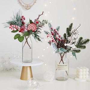 Artificial Christmas greenery with pine cones and candy canes in glass vase decoration