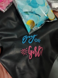 Detail of 36-inch black Boy or Girl gender reveal balloon with blue and gold confetti