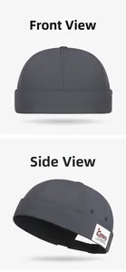 Detail of dark grey docker hat featuring camping woven label and adjustable strap