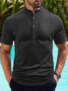 Close-up of black short-sleeve polo shirt with vertical texture and three-button neckline