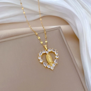 Luxurious gold heart pendant necklace with crystal zircons and religious relief detail