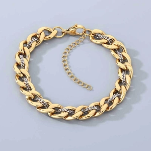 Detail of chunky two-tone gold and silver Cuban chain bracelet with lobster clasp
