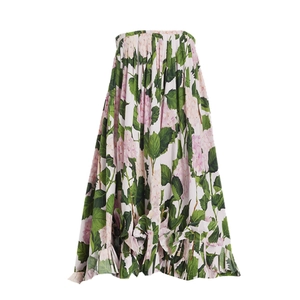 Macro detail of high-waist maxi skirt with pink hydrangea print and pleated texture