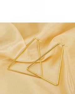 Detail of large 18K gold plated geometric triangle earrings on premium champagne silk fabric