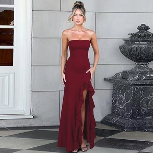 Detail of burgundy strapless gown featuring a thigh-high slit and ruffle hem for formal events