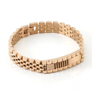 Detail of rose gold watchband-style link bracelet with a secure folding clasp closure