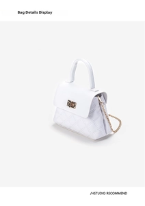 Detail of white quilted handbag showing golden lock closure and premium leather texture