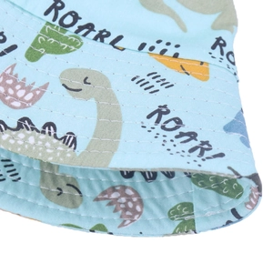 Detailed close-up of blue dinosaur bucket hat with white stitching and quality fabric texture