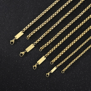 Detailed view of golden stainless steel box chains with blank customizable rectangle tags