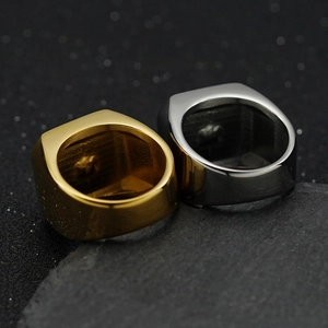 Detailed close-up of gold and silver signet rings with inner star-shaped engraving