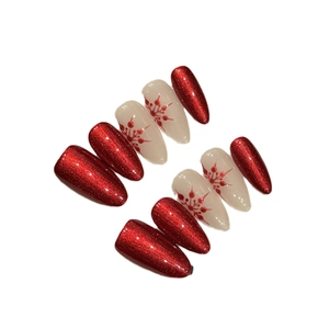Handmade red cat eye and white snowflake almond press-on nails set for festive manicure