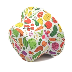 Detailed close-up of a bucket hat featuring colorful all-over vegetable prints on canvas