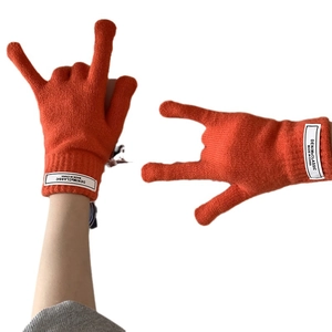 Vibrant orange winter knit gloves with touch screen tips and white cuff labels