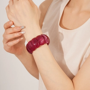 Detail of a purple translucent acrylic geometric bangle with rounded resin segments