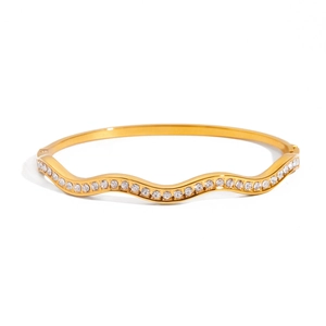 Polished 18K gold plated stainless steel wave bangle with cubic zirconia crystals