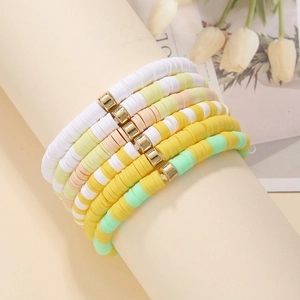 6-piece bohemian colorful heishi bead bracelet set with gold spacers on a display stand