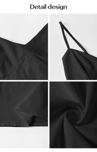 Detail view of black V-neck spaghetti strap dress showing fabric texture and hemline stitches