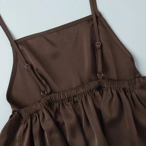 Macro shot of adjustable shoulder straps and elastic gathering on a satin top back