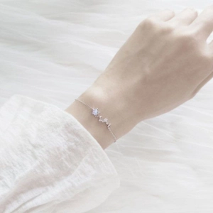 Elegant silver star and moon chain bracelet with blue zircon stones on woman's wrist