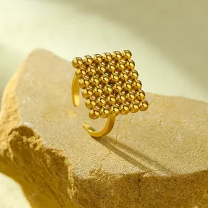 Detailed macro shot of 18K gold plated ring with square cluster design and dimensions