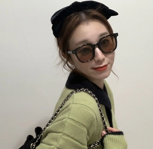 Fashionable oversized black sunglasses for women paired with a velvet bow headband