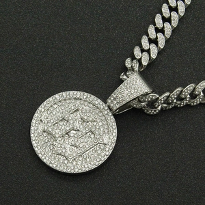 Close-up of silver Cuban chain necklace with a round iced-out rhinestone pendant