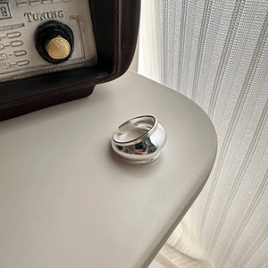 Minimalist S925 sterling silver open ring with chunky wavy design on an aesthetic desk