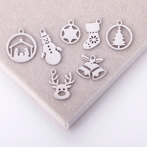 Detailed view of silver stainless steel Christmas charms including snowman and reindeer