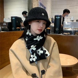 Women's black teddy bucket hat with 'D' charm and floral knit scarf on model