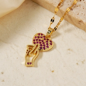 Elegant gold heart gesture necklace featuring a red zircon-encrusted heart pendant
