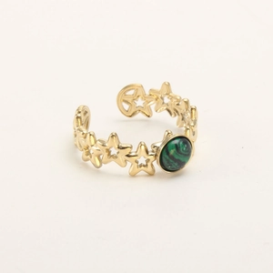 Detailed macro view of gold-plated star hollow ring featuring a green malachite stone