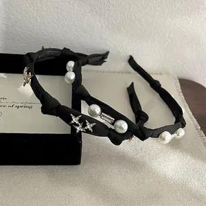 Elegant black fabric headbands with pearls, stars and rhinestones in a cozy lifestyle setting