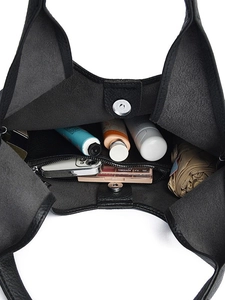 Large black leather tote bag interior showing spacious capacity for phone and umbrella