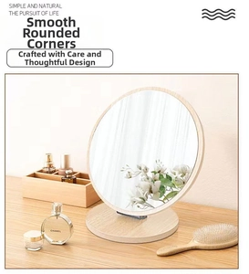 Detail of round desktop makeup mirror with a smooth wooden frame and stable base