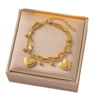 Double-layered gold titanium steel bracelet featuring heart pendants and polished beads