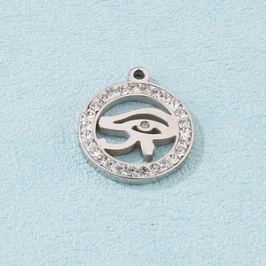 Silver stainless steel Eye of Horus pendant with clear zircons on a blue background