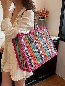 Large colorful striped woven tote bag with brown leather handles for beach vacations