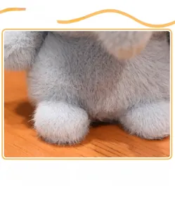 Detail view of plush toy showing thick grey faux fur texture and soft filling material